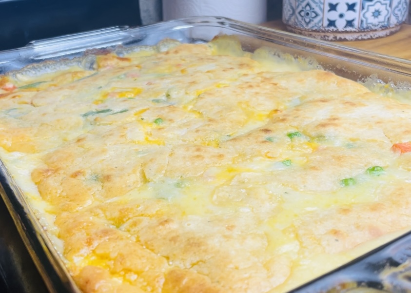 A large glass baking dish with Cheddar Bay Biscuit Chicken Pot Pie layered in it.