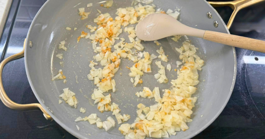 Onion and garlic sauteed in a large skillet to make the Easy One-Pot Halloween Goulash Recipe.