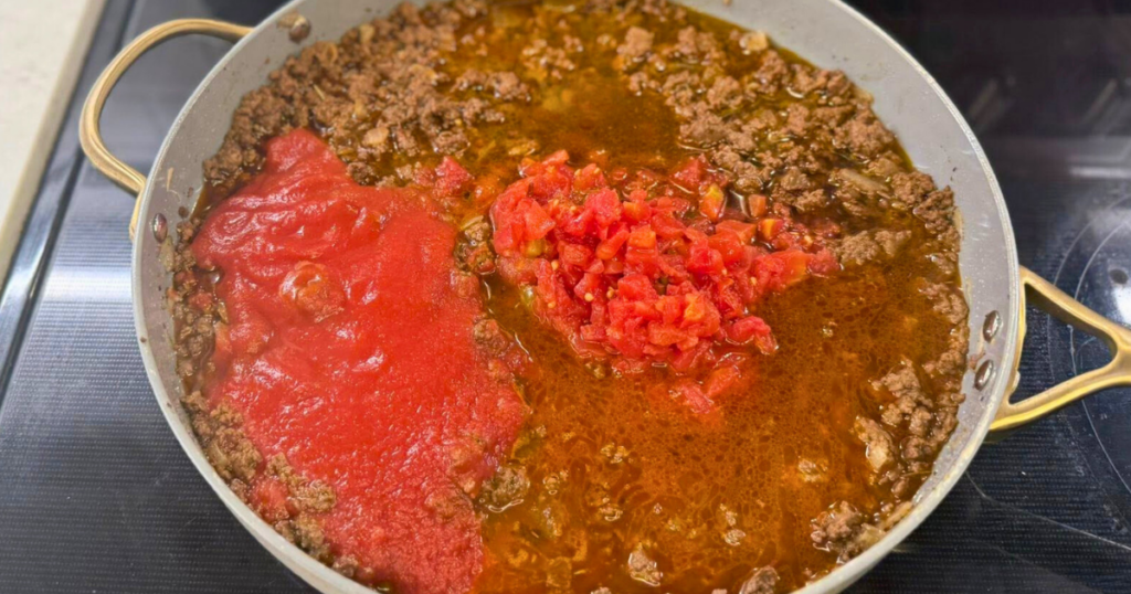 Ground deer cooked with tomatoes and onions to make the Easy One-Pot Halloween Goulash Recipe.