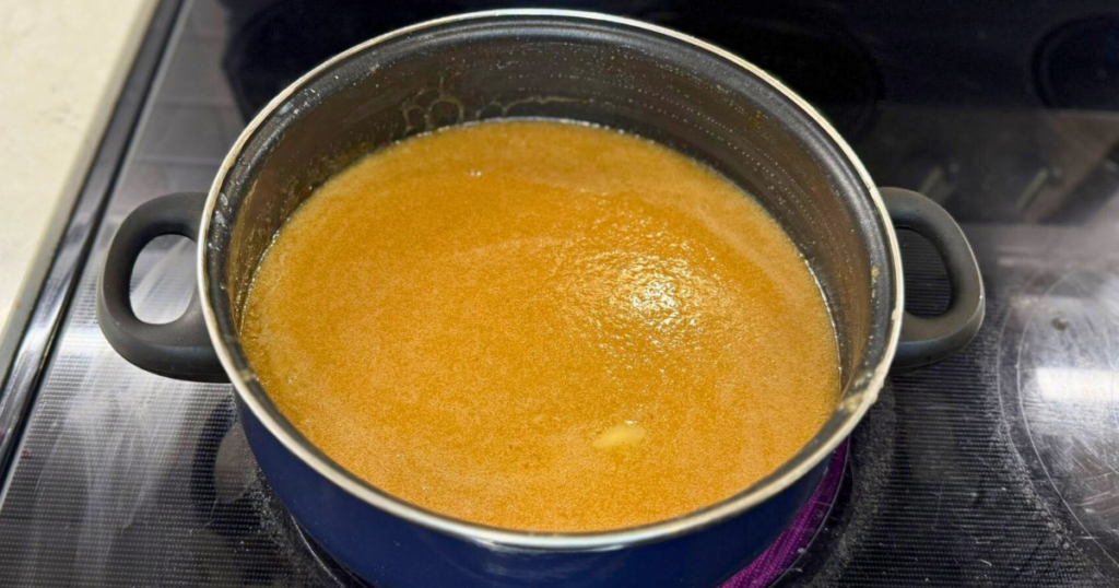 Homemade Apple Cider Salted Caramel Recipe melted on the stove.